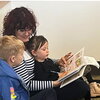 Mroz reading a French book to two kids