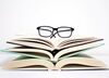 glasses on a pile of books