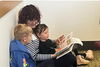 Mroz reading a French book to two kids